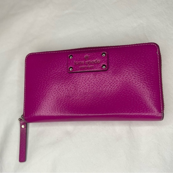 Leather Zip Around Wallet by Kate Spade in magenta.

Length: 7.75",  Height: 4" - Picture 1 of 6